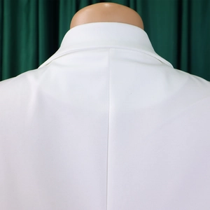 Close-up of elegant white sleeveless jumpsuit collar and back stitching details