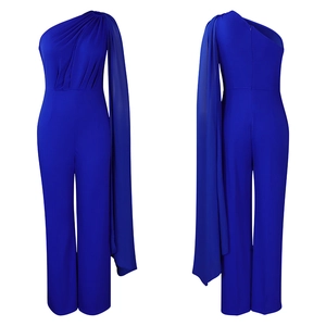 Detail of royal blue one-shoulder jumpsuit with draped cape sleeve and pleats