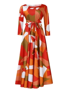 Detail of artistic geometric print maxi dress with belted waist and long sleeves