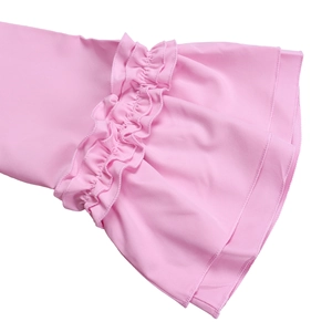 Close-up of pink dress sleeve featuring flared ruffle cuffs and fine double-line stitching