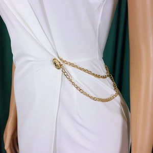 Close-up of golden multi-layer chain belt with embossed vintage coin buckle on mannequin