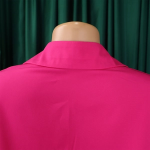 Detail of fuchsia loose-fit dress collar and back stitching on a mannequin