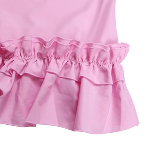 Detail of solid pink dress featuring elegant double-layer ruffle hem and cotton fabric