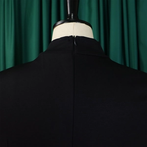 Detail view of the back collar with high neck design and hidden zipper on black dress