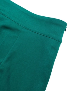 Detail of teal pleated skirt waist featuring seamless invisible zipper and neat stitching