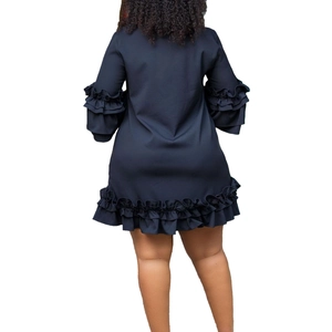 Detail view of tiered ruffle sleeves and hemline on a navy blue A-line dress back