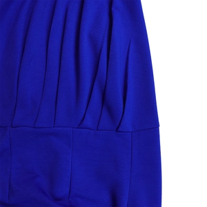 Macro view of detailed ruching and fine stitching on a royal blue one-shoulder jumpsuit