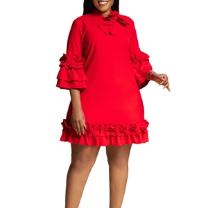 Detail of red short dress featuring tiered ruffle sleeves and a stylish bow neckline