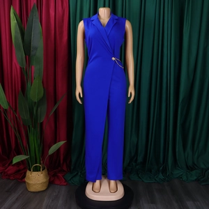 Detail of royal blue sleeveless jumpsuit featuring V-neck lapel and metal chain waist buckle