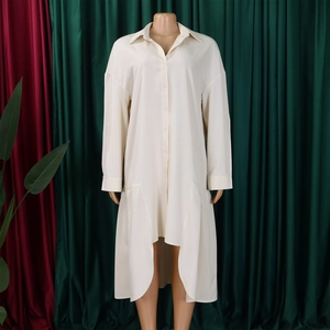 Detail view of cream white long sleeve shirt dress with asymmetric hem and button closure