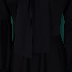 Close-up of black dress featuring a self-tie bow neck and elegant puff sleeves detail