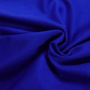 Macro shot of royal blue knitted fabric texture with elegant draping and subtle glossy finish