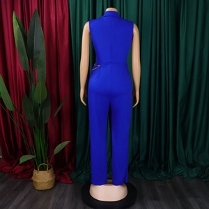 Detail of royal blue sleeveless jumpsuit with waist chain and structured lapel design