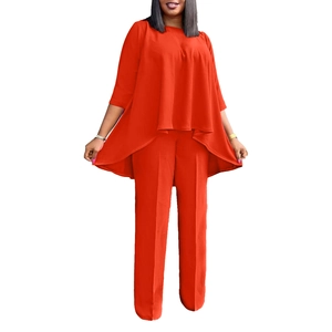 Close-up of vibrant orange-red two-piece set featuring layered top and wide-leg trousers