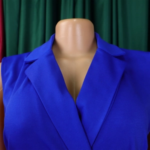 Detail of the elegant royal blue sleeveless jumpsuit with chic notched lapel and textured fabric