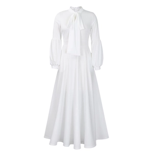 Detailed view of elegant white maxi dress with puff sleeves and bow tie neckline