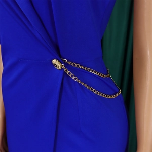 Close-up of royal blue jumpsuit waist with gold Medusa buttons and hanging curb chains