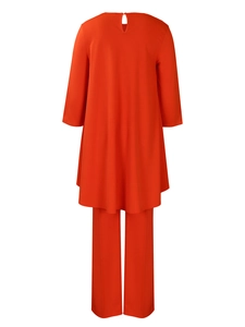 Detail view of bright orange two-piece set featuring back keyhole button closure and long top