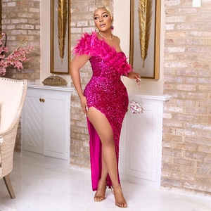 Close-up of rose red sequined gown featuring feather neckline and thigh-high side slit