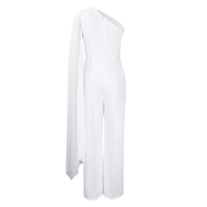 Detail of white one-shoulder jumpsuit featuring an asymmetrical flowing chiffon cape design