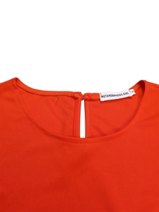 Detail view of the bright orange round neck with a keyhole back design on a knit top