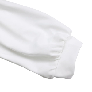 Detailed close-up of a white dress sleeve featuring a ribbed cuff and smooth knit fabric texture