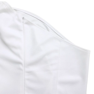 Detail of invisible zipper construction and vertical seams on white one-shoulder jumpsuit