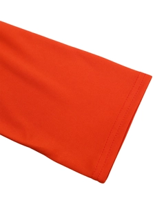 Detailed close-up of double-stitched seam on bright orange knit fabric garment