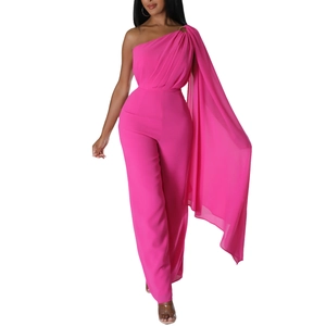 Detail of elegant one-shoulder fuchsia jumpsuit with long flowing cape and wide-leg design