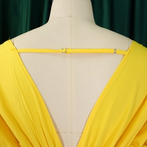 Détail de la combinaison jaune avec dos en V plongeant et boucle métallique réglable