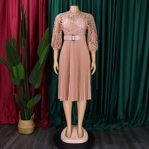 Close-up of pink lace crochet hollow bodice and pleated chiffon skirt with belted waist