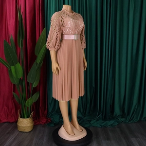 Detail of dusty pink dress featuring floral lace hollow out bodice and pleated skirt fabric