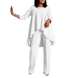 Detail view of women's white two-piece set featuring asymmetrical tunic and long trousers