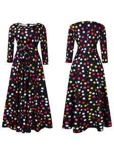 Detail view showing colorful polka dot pattern and waist bow tie on black long sleeve dress