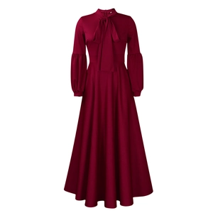 Detail of burgundy maxi dress featuring an elegant neck tie and puff lantern sleeves