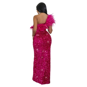 Detail of rose red sequin gown with feather shoulder trim and fitted silhouette