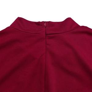 Detail shot of the invisible zipper and stand collar on a burgundy high waist dress