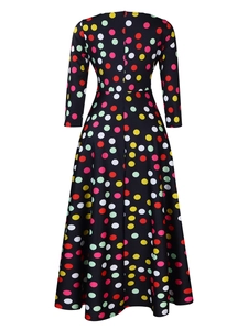 Rear view of vintage floral maxi dress with colorful polka dots and a full flared skirt