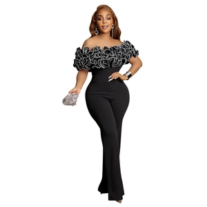 Detail of elegant black off-shoulder jumpsuit with layered white-edged ruffles and slim fit