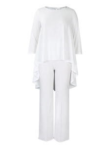 Detail of white two-piece set featuring asymmetrical hem top and wide leg trousers