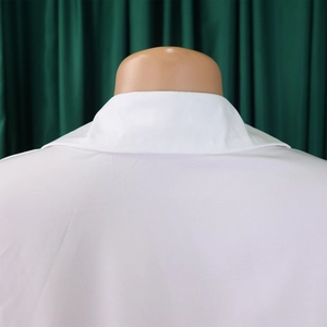 Detail view of the back collar and shoulder tailoring of a white long sleeve shirt