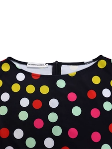 Detailed view of colorful polka dot print dress with round neckline and hidden back zipper