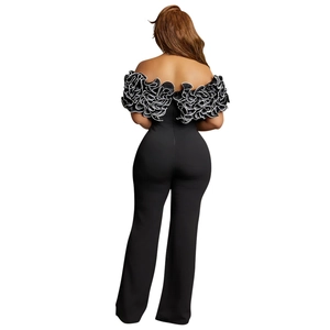 Detailed back view of off-the-shoulder jumpsuit with black and white ruffled neckline