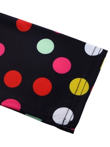 Detail of short sleeve cuff with colorful large polka dots and double stitching