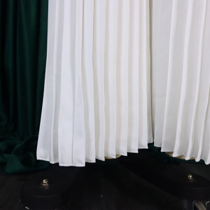 Détail du bas de la combinaison blanche à jambes larges avec plis verticaux délicats