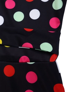 Detail of colorful polka dot print on premium black fabric with neat stitching seam