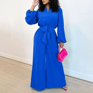 Detail view of the royal blue long sleeve jumpsuit with waist tie and lapel collar design