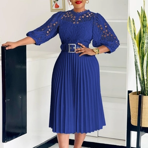 Detailed view of blue dress with floral lace bodice, pleated skirt and metal buckle belt