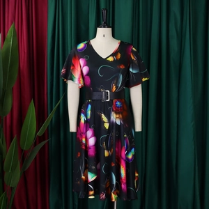 Détail d'une robe d'été avec imprimé papillon, col en V et ceinture noire ajustée