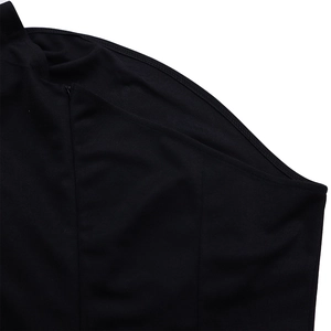 Macro detail of the invisible side zipper on a solid black elegant formal jumpsuit